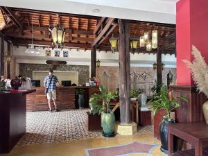 a man standing at the counter of a restaurant at Mekong Angkor Palace Inn in Siem Reap