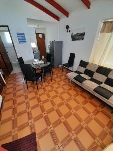 a living room with a couch and a table and chairs at Cabañas Herradura Oriente in Coquimbo