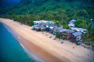 an aerial view of a beach with a group of houses at Beach Shack Tioman - Beachfront Seaview in Tioman Island