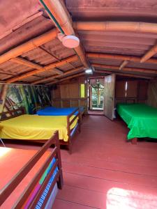 a room with two beds and a green slide at Finca La Divisa. Senderos de la Montaña in Pereira