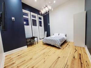 a bedroom with a bed and a wooden floor at Executive Room in Toronto next to Yorkdale shopping centre in Toronto