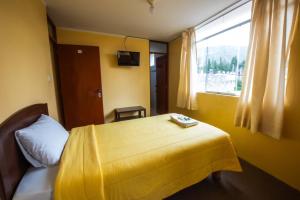 A bed or beds in a room at La Posada de Lucero