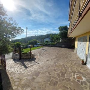 a stone driveway next to a building with a fence at La Pineta, 26 - 5 in Casarza Ligure