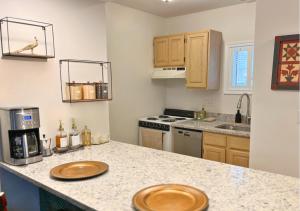 a kitchen with a counter with two wooden plates on it at Cozy Villa 3 mins to Mohegan- Fully Stocked with King Bed & Fireplace- Jacuzzi, Saltwater Pools, Sauna in Norwich +18 photos
