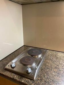 a stove sitting on top of a kitchen counter at Fully Furnished Condo in Mactan Newtown with WIFI -Infinity Pool in Lapu Lapu City