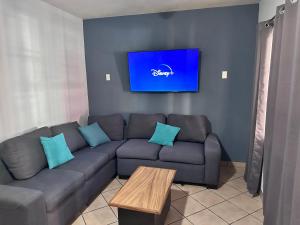 a living room with a couch and a tv at Casa Valentina in Sayula