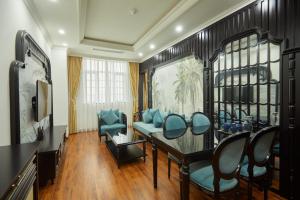 a dining room with blue chairs and a table at Union Inn+ in Ha Long