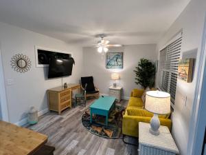 a living room with a couch and a tv at 875 Oasis 2 in Vero Beach