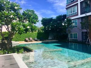 a swimming pool in front of a building at Baan Kun Koey Condo Huahin B103,Pool View,Heart of Huahin,Near Blue Ports,300m from Beach in Hua Hin