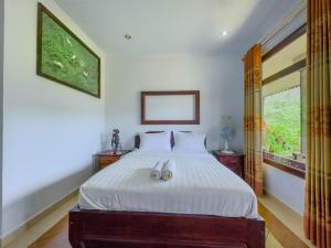 Postel nebo postele na pokoji v ubytování Mulia Garden Bungalows - Monthly Rate Available