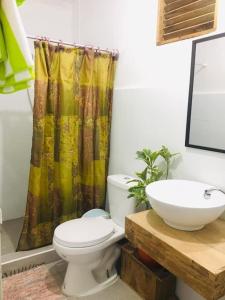 a bathroom with a toilet and a sink at Avong Nen Kitma in Baguio