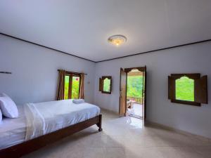Postel nebo postele na pokoji v ubytování Mulia Garden Bungalows - Monthly Rate Available
