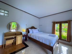 Postel nebo postele na pokoji v ubytování Mulia Garden Bungalows - Monthly Rate Available
