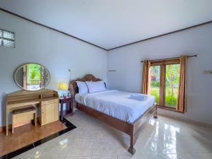 Postel nebo postele na pokoji v ubytování Mulia Garden Bungalows - Monthly Rate Available