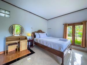 Postel nebo postele na pokoji v ubytování Mulia Garden Bungalows - Monthly Rate Available