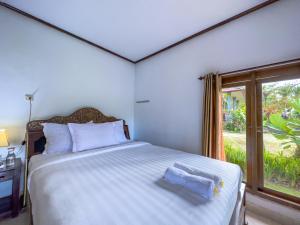 Postel nebo postele na pokoji v ubytování Mulia Garden Bungalows - Monthly Rate Available