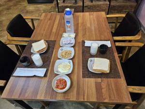 a wooden table with plates of food on it at Star House in Jeju