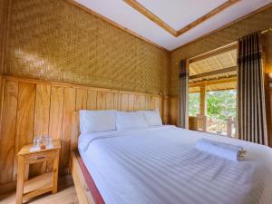 Postel nebo postele na pokoji v ubytování Mulia Garden Bungalows - Monthly Rate Available