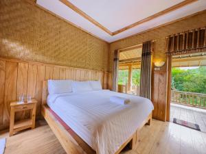 Postel nebo postele na pokoji v ubytování Mulia Garden Bungalows - Monthly Rate Available