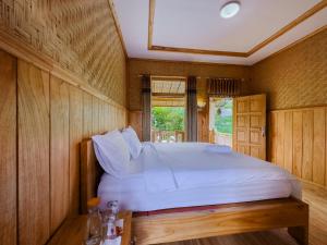 Postel nebo postele na pokoji v ubytování Mulia Garden Bungalows - Monthly Rate Available