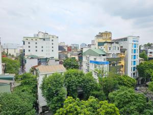 a city skyline with tall buildings and trees at Hilton Garden Inn Hanoi in Hanoi