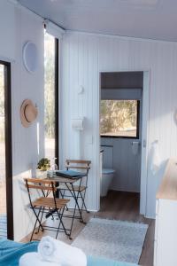 a room with a table and chairs and a bathroom at Djindarup Retreat 1 in Prevelly