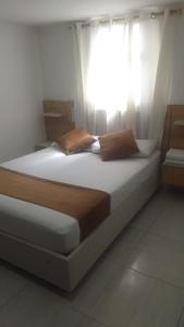 Säng eller sängar i ett rum på Hotel Gutier Rionegro