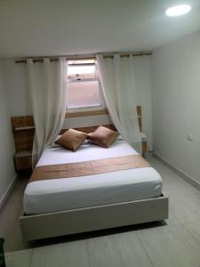 Postel nebo postele na pokoji v ubytování Hotel Gutier Rionegro