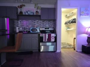 a kitchen with a stove top oven next to a refrigerator at Unlv Cox studio in Las Vegas