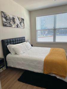 a bedroom with a large bed and a window at Devine living in the med center in Houston