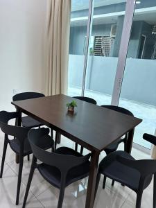 a table and chairs in a room with a window at Fourteen Homestay in Port Dickson