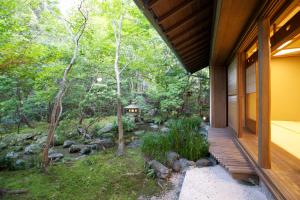 a house in the woods with a view of a creek at Hanzuiryo in Unzen