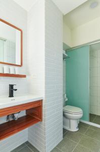 a bathroom with a toilet and a sink and a mirror at Xiangyue 38 Homestay in Dongshan +25 photos