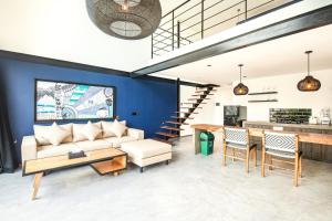 a living room with a couch and a table at New Duplex Apartment 200m To Beach Canggu in Canggu