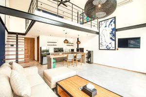 an open living room with a couch and a table at New Duplex Apartment 200m To Beach Canggu in Canggu