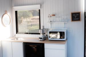a kitchen with a microwave on a counter next to a sink at Djindarup Retreat 3 in Prevelly