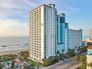 a view of a tall building next to the beach at Oceanfront Oasis in Myrtle Beach