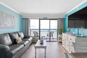 sala de estar con sofá y mesa en Oceanfront Oasis en Myrtle Beach