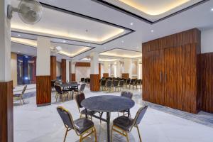 einen Konferenzraum mit Tischen, Stühlen und Holzschränken in der Unterkunft Super Townhouse 1363 Hotel Lindo Lugar in Alwar