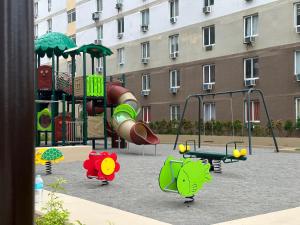 a playground with a slide and swings at Lapu-Lapu City Condo in Lapu Lapu City