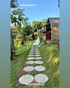 a stepping stone path in a yard with a house at Orangutan Bungalow in Bukit Lawang