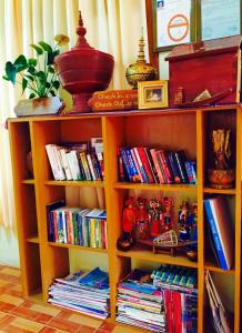 a book shelf filled with lots of books at Inle Star Hotel in Nyaungshwe Township
