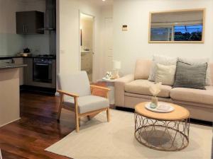 a living room with a couch and a table at Delaware Retreat in Mount Panorama