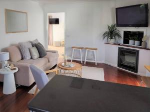 a living room with a couch and a fireplace at Delaware Retreat in Mount Panorama