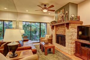 a living room with a fireplace and a tv at River Remedy CW C110 in New Braunfels