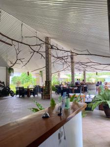 a restaurant with a bar with branches hanging from the ceiling at Buona Vita resort in Panglao