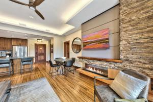 a living room with a fireplace and a kitchen at Zalanta 222 - Sun Fun and Mountain Runs in Stateline