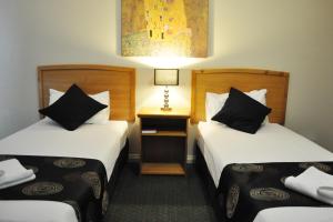 Postel nebo postele na pokoji v ubytování Meadowbrook Hotel Brisbane