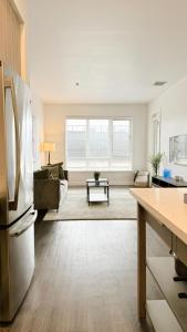 an open kitchen and living room with a refrigerator at Cozy Glendale Apartment in Los Angeles