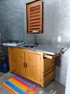 a kitchen with a sink and a counter top at Chalé Rj Rio in Santo Amaro